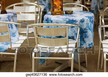 Tables and chairs in a restaurant View Large Photo Image Stock Photograph - Tables and chairs in a restaurant. Fotosearch