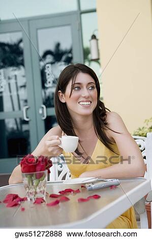 Stock Photo - Teenage girl holding a cup of tea and smiling. Fotosearch
