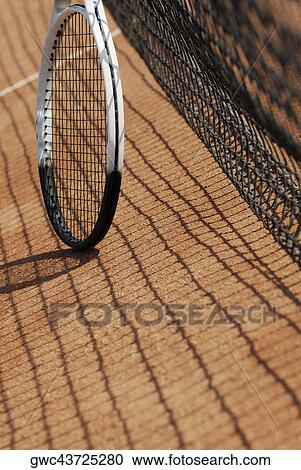 Tennis racket near a tennis net on a tennis court View Large Photo Image Stock Image - Tennis racket near a tennis net on a tennis court. Fotosearch