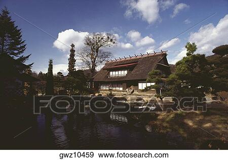 Stock Photo - Thatched farm house in front of a lake, Hakone, Kanagawa Prefecture, Japan. Fotosearch