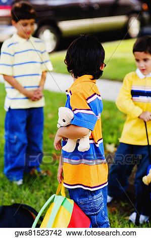 Three schoolboys playing in a lawn View Large Photo Image Stock Image - Three schoolboys playing in a lawn. Fotosearch