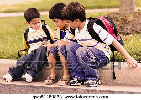 Three schoolboys sitting together View Large Photo Image Stock Photo - Three schoolboys sitting together. Fotosearch