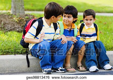 Three schoolboys sitting together View Large Photo Image Stock Photograph - Three schoolboys sitting together. Fotosearch