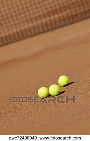Three tennis balls on a tennis court View Large Photo Image Stock Photo - Three tennis balls on a tennis court. Fotosearch