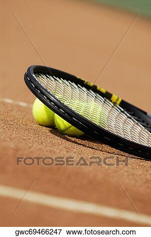 Three tennis balls under a tennis racket View Large Photo Image Stock Photo - Three tennis balls under a tennis racket. Fotosearch