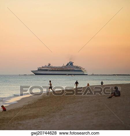 Tourist on the beach at dusk View Large Photo Image Stock Photo - Tourist on the beach at dusk. Fotosearch