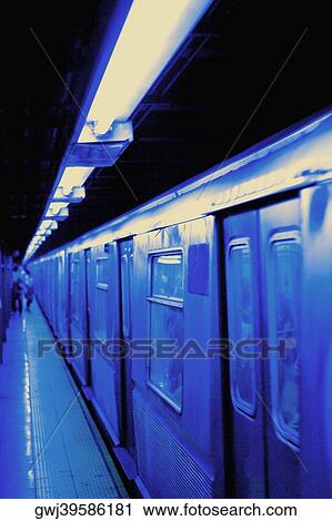Train at a railroad station platform View Large Photo Image Stock Image - Train at a railroad station platform. Fotosearch