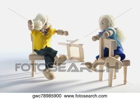 Two dolls sitting on chairs View Large Photo Image Stock Image - Two dolls sitting on chairs. Fotosearch