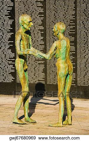 Two human sculptures in front of a wall View Large Photo Image Stock Photo - Two human sculptures in front of a wall. Fotosearch