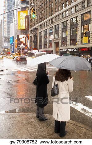 Two women standing at the roadside View Large Photo Image Stock Image - Two women standing at the roadside. Fotosearch