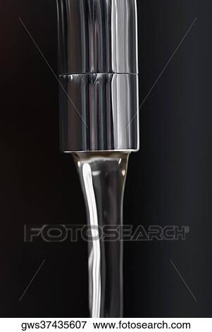 Water flowing out of a faucet View Large Photo Image Stock Photo - Water flowing out of a faucet. Fotosearch