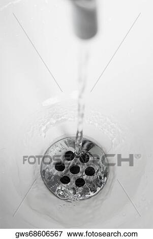 Stock Photo - Water flowing out of a faucet. Fotosearch