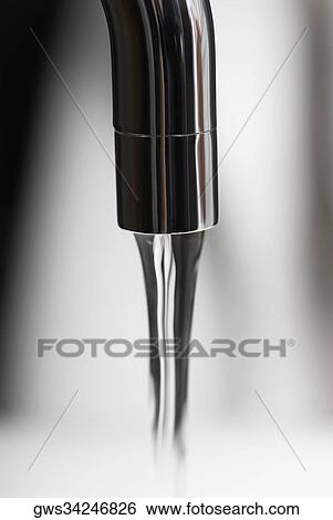 Water flowing out of a faucet View Large Photo Image Stock Photograph - Water flowing out of a faucet. Fotosearch