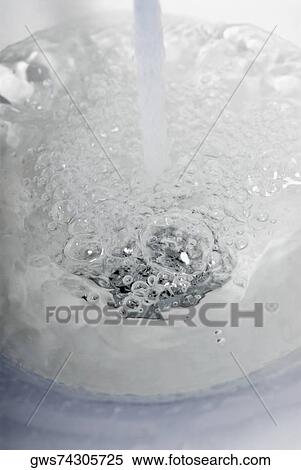 Water flowing out of a faucet View Large Photo Image Stock Photography - Water flowing out of a faucet. Fotosearch