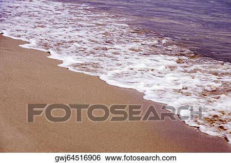 Stock Photograph - Waves on the beach. Fotosearch