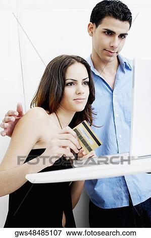 Stock Photo - Young couple online shopping. Fotosearch