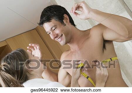 Young woman measuring a mid adult man's biceps with a tape measure View Large Photo Image Stock Image - Young woman measuring a mid adult man's biceps with a tape measure. Fotosearch