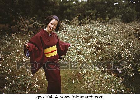 Young woman smiling in traditional Japanese clothing, Kamakura, Kanagawa Prefecture, Japan View Large Photo Image Picture - Young woman smiling in traditional Japanese clothing, Kamakura, Kanagawa Prefecture, Japan. Fotosearch
