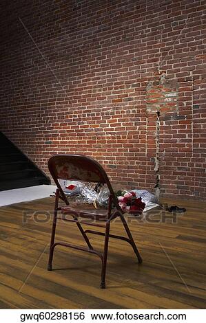Stock Photograph - Bouquet of flowers on a chair. Fotosearch