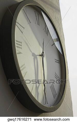 Stock Image - Close-up of a clock hanging on a wall. Fotosearch