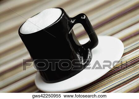 Stock Photography - Close-up of a coffee cup on a saucer. Fotosearch