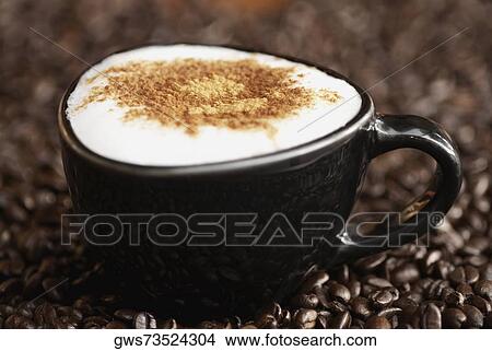 Close-up of a coffee cup with coffee beans View Large Photo Image Picture - Close-up of a coffee cup with coffee beans. Fotosearch