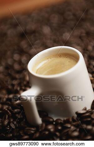 Close-up of a coffee cup with coffee beans View Large Photo Image Stock Image - Close-up of a coffee cup with coffee beans. Fotosearch