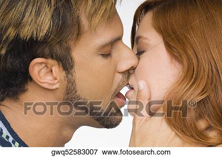 Stock Photo - Close-up of a couple kissing each other. Fotosearch
