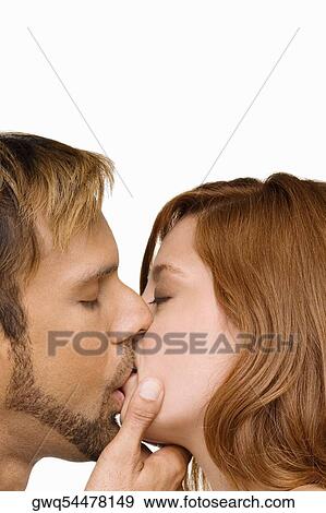 Stock Photo - Close-up of a couple kissing each other. Fotosearch