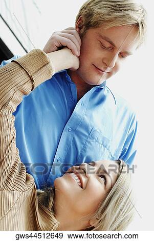 Stock Photo - Close-up of a couple looking at each other and smiling. Fotosearch