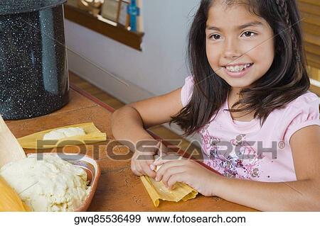 Close-up of a girl preparing bread View Large Photo Image Stock Photo - Close-up of a girl preparing bread. Fotosearch