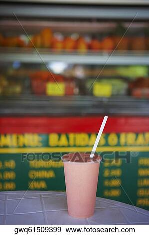Close-up of a glass of juice on a table at a juice bar View Large Photo Image Stock Photo - Close-up of a glass of juice on a table at a juice bar. Fotosearch
