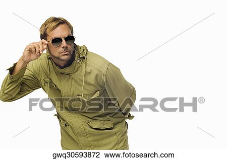 Close-up of a mid adult man adjusting his sunglasses View Large Photo Image Stock Image - Close-up of a mid adult man adjusting his sunglasses. Fotosearch