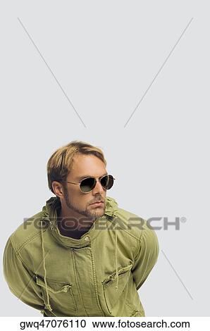 Close-up of a mid adult man wearing sunglasses and bending forward View Large Photo Image Stock Image - Close-up of a mid adult man wearing sunglasses and bending forward. Fotosearch