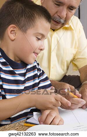 Close-up of a senior man teaching his grandson View Large Photo Image Stock Image - Close-up of a senior man teaching his grandson. Fotosearch