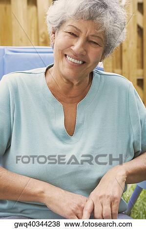 Close-up of a senior woman smiling View Large Photo Image Stock Photo - Close-up of a senior woman smiling. Fotosearch
