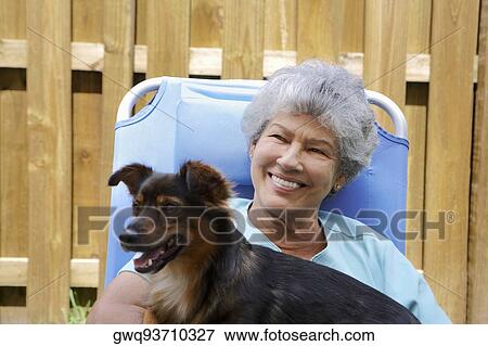 Close-up of a senior woman with a dog and smiling View Large Photo Image Stock Photo - Close-up of a senior woman with a dog and smiling. Fotosearch