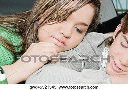 Close-up of a teenage boy and a young woman resting together View Large Photo Image Stock Photography - Close-up of a teenage boy and a young woman resting together. Fotosearch