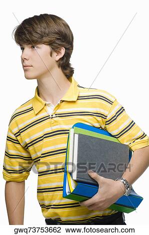 Close-up of a teenage boy carrying books and ring binders View Large Photo Image Stock Image - Close-up of a teenage boy carrying books and ring binders. Fotosearch