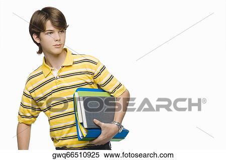 Stock Photography - Close-up of a teenage boy carrying books and ring binders. Fotosearch