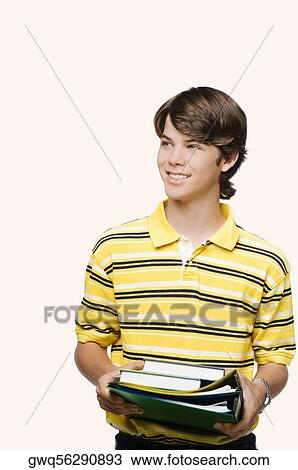 Close-up of a teenage boy holding books and ring binders View Large Photo Image Stock Image - Close-up of a teenage boy holding books and ring binders. Fotosearch