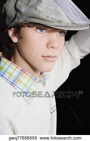 Close-up of a teenage boy wearing a flat cap View Large Photo Image Stock Photography - Close-up of a teenage boy wearing a flat cap. Fotosearch