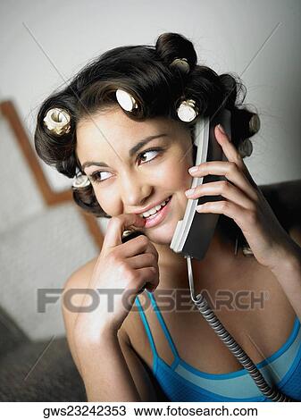 Stock Image - Close-up of a teenage girl talking on the telephone. Fotosearch