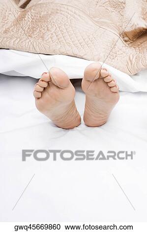 Close-up of a woman's feet on the bed View Large Photo Image Stock Image - Close-up of a woman's feet on the bed. Fotosearch