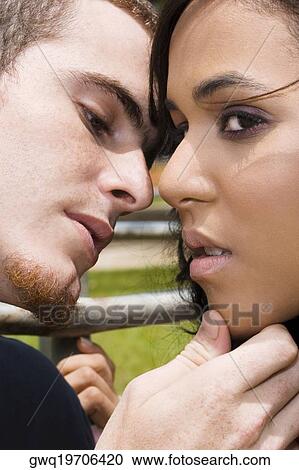 Close-up of a young man about to kiss a teenage girl View Large Photo Image Stock Image - Close-up of a young man about to kiss a teenage girl. Fotosearch