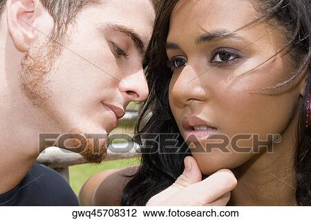 Close-up of a young man about to kiss a teenage girl View Large Photo Image Stock Image - Close-up of a young man about to kiss a teenage girl. Fotosearch