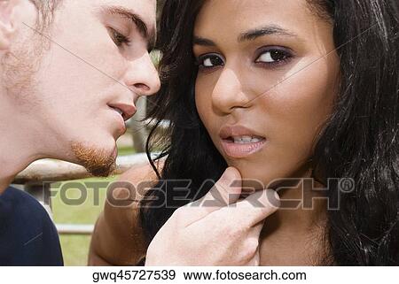 Close-up of a young man about to kiss a teenage girl View Large Photo Image Stock Photo - Close-up of a young man about to kiss a teenage girl. Fotosearch