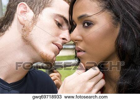 Close-up of a young man kissing a teenage girl View Large Photo Image Stock Image - Close-up of a young man kissing a teenage girl. Fotosearch