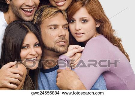 Close-up of a young man smiling with his friends View Large Photo Image Picture - Close-up of a young man smiling with his friends. Fotosearch
