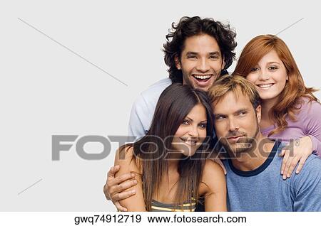 Stock Photo - Close-up of a young man smiling with his friends. Fotosearch